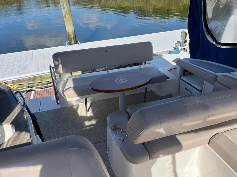 Slide: The Image of 2011 Regal 35 Express Cruiser interior with seating and table by the water. - 31