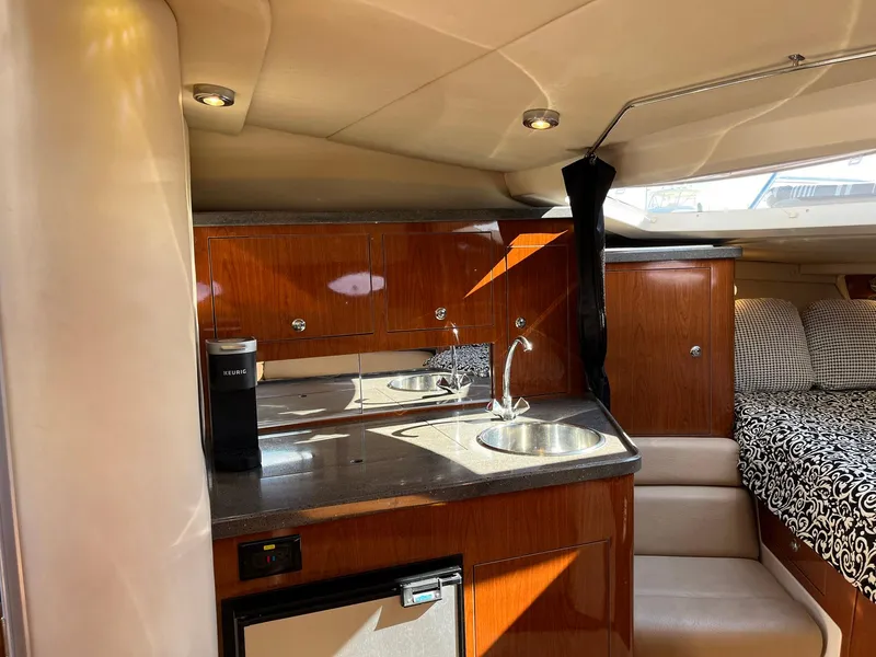 Slide: The Image of Interior of 2011 Regal 35 Express Cruiser with kitchenette and seating area. - 4