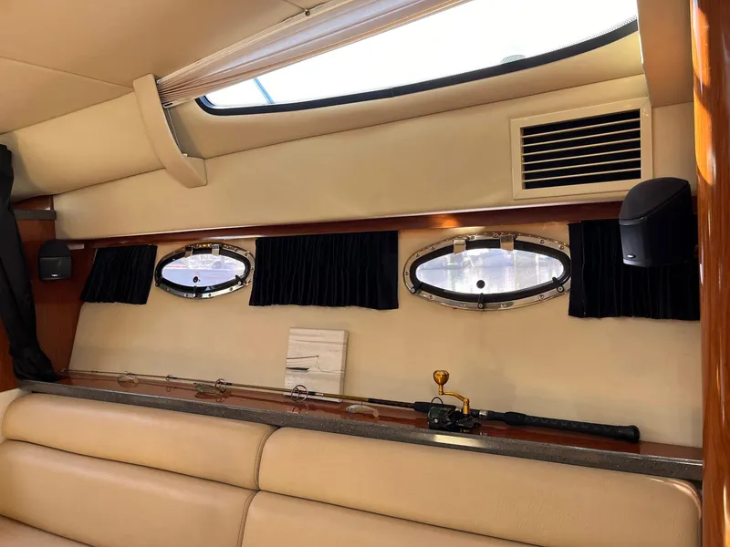 Slide: The Image of Interior of 2011 Regal 35 Express Cruiser with portholes and fishing rod. - 6