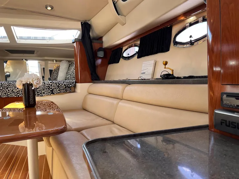 Slide: The Image of Interior of 2011 Regal 35 Express Cruiser with beige seating and elegant decor. - 7