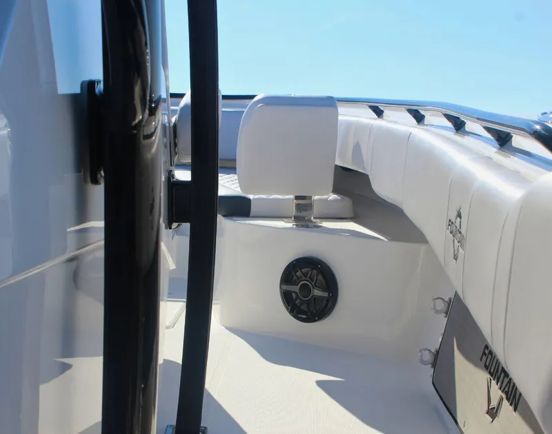Slide: The Image of 2025 Fountain 34 CC boat interior with white seating and speaker, showcasing modern design. - 11