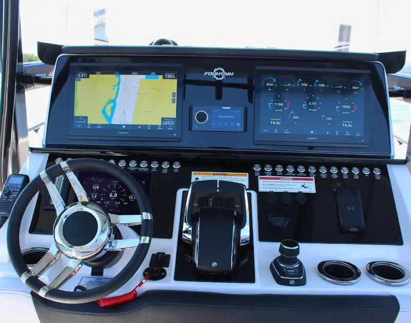 Slide: The Image of 2025 Fountain 34 CC boat dashboard with navigation and control systems. - 14