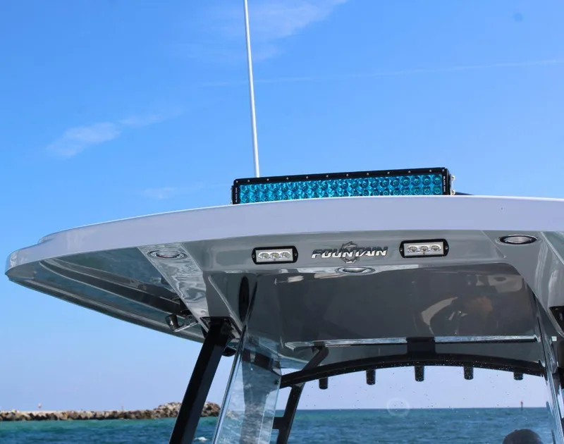 Slide: The Image of 2025 Fountain 34 CC boat top view with blue sky and ocean background. - 19