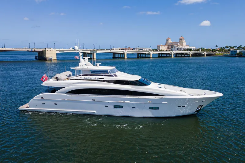 The Image of Luxurious 2014 Horizon RP 110 yacht cruising near a scenic bridge and waterfront. - 0