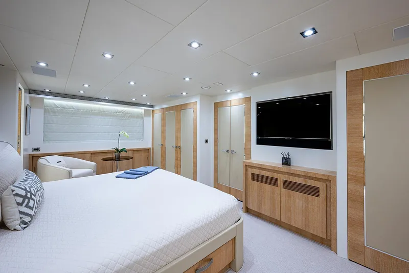 Slide: The Image of Luxurious bedroom interior on 2014 Horizon RP 110 yacht, featuring modern decor and a flat-screen TV. - 16