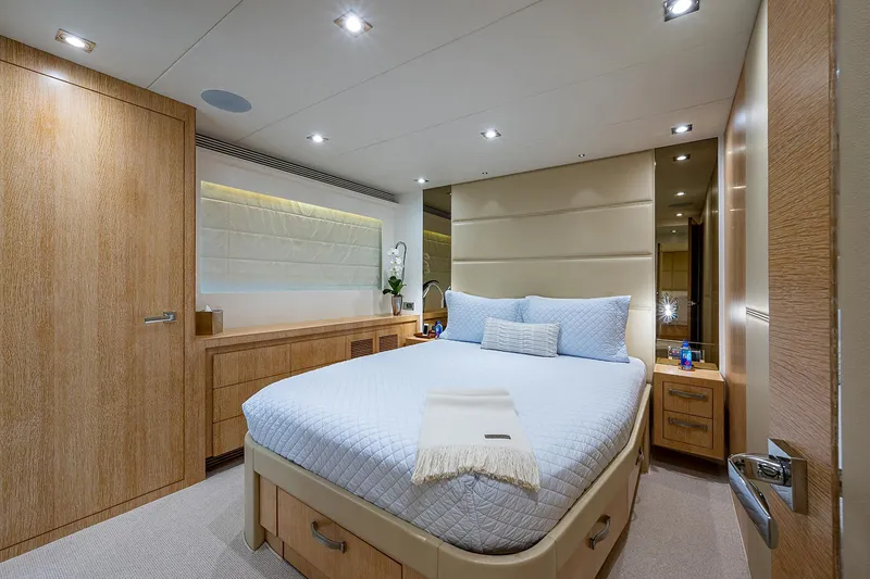 Slide: The Image of Luxurious bedroom interior on Horizon RP 110 yacht, 2014 model, featuring elegant wood finishes. - 21