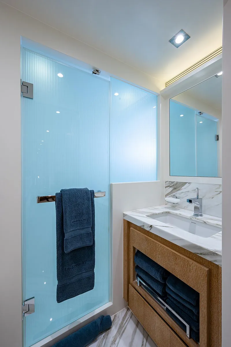 Slide: The Image of Luxurious bathroom in 2014 Horizon RP 110 yacht with modern fixtures and blue accents. - 23