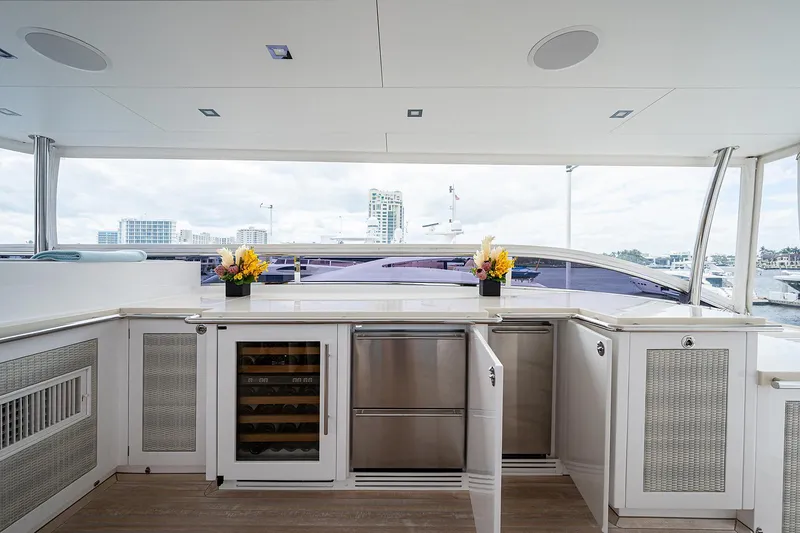 Slide: The Image of Luxurious yacht interior with modern kitchen, Horizon RP 110, 2014 model, featuring sleek cabinetry and appliances. - 35