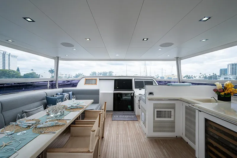 Slide: The Image of Luxurious Horizon RP 110 yacht interior with elegant dining area, modern kitchen, and scenic views. - 36