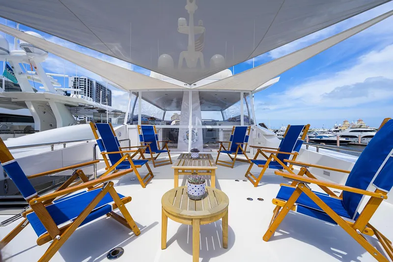 Slide: The Image of Luxury Horizon RP 110 yacht deck with blue chairs, wooden table, marina view, 2014 model. - 41
