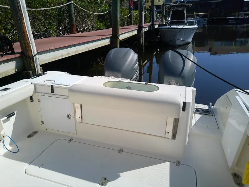 Slide: The Image of 2006 Pursuit 3070 Offshore boat docked, featuring dual outboard motors. - 15