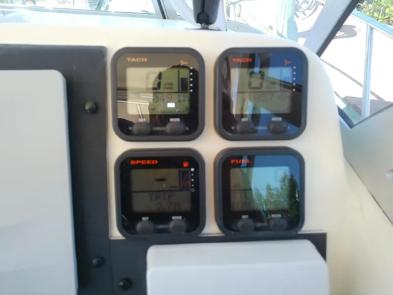Slide: The Image of Dashboard of a 2006 Pursuit 3070 Offshore boat with tachometer and speed gauges. - 28