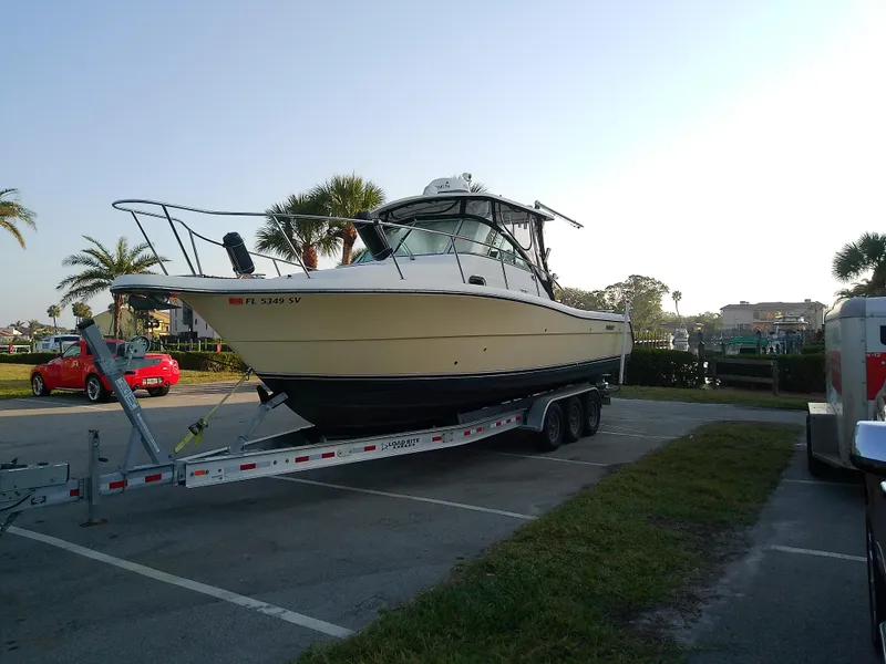 Slide: The Image of 2006 Pursuit 3070 Offshore boat on trailer in parking lot. - 8