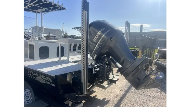 Slide: The Image of 2016 Majek 25 Xtreme boat with Yamaha outboard motor, parked outdoors. - 5