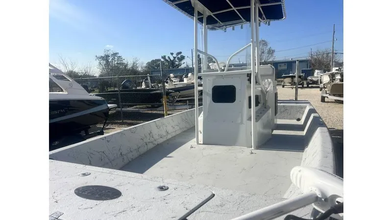 Slide: The Image of 2016 Majek 25 Xtreme boat with spacious deck and T-top in a marina setting. - 7