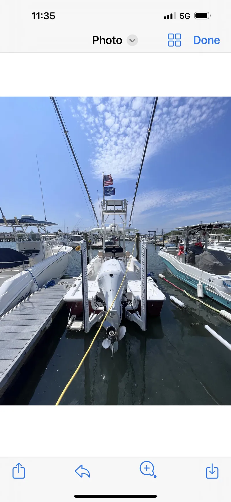 Slide: The Image of 2019 Sportsman Masters 247 Bay Boat docked at marina under clear sky. - 11