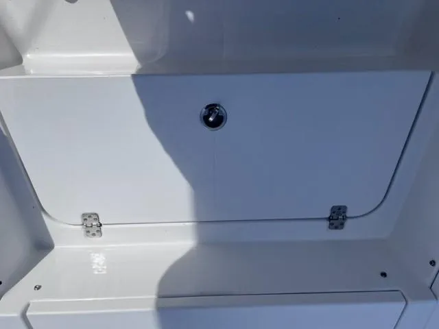 Slide: The Image of 2019 Sportsman Masters 247 Bay Boat storage compartment with latch and hinges. - 13