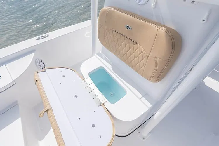 Slide: The Image of 2019 Sportsman Masters 247 Bay Boat interior with cushioned seating and storage compartment. - 14