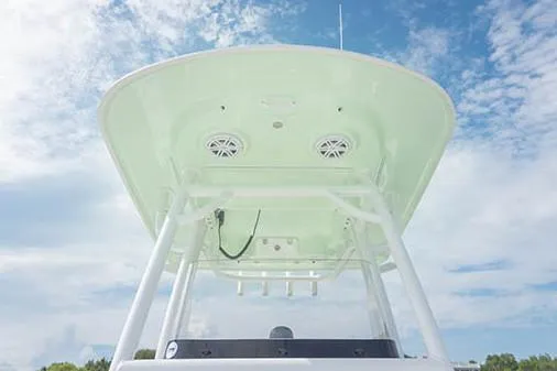 Slide: The Image of 2019 Sportsman Masters 247 Bay Boat T-top against a blue sky. - 15