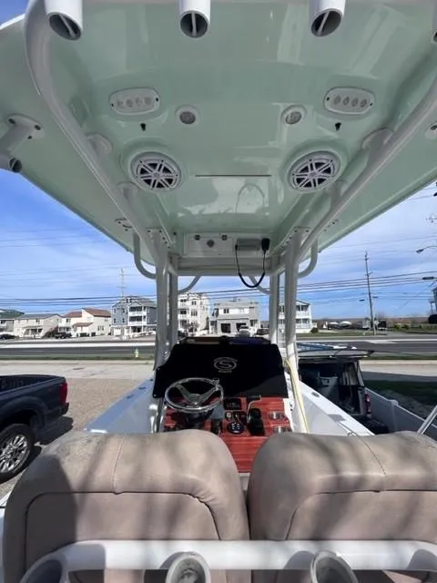 Slide: The Image of 2019 Sportsman Masters 247 Bay Boat interior with T-top and console view. - 16