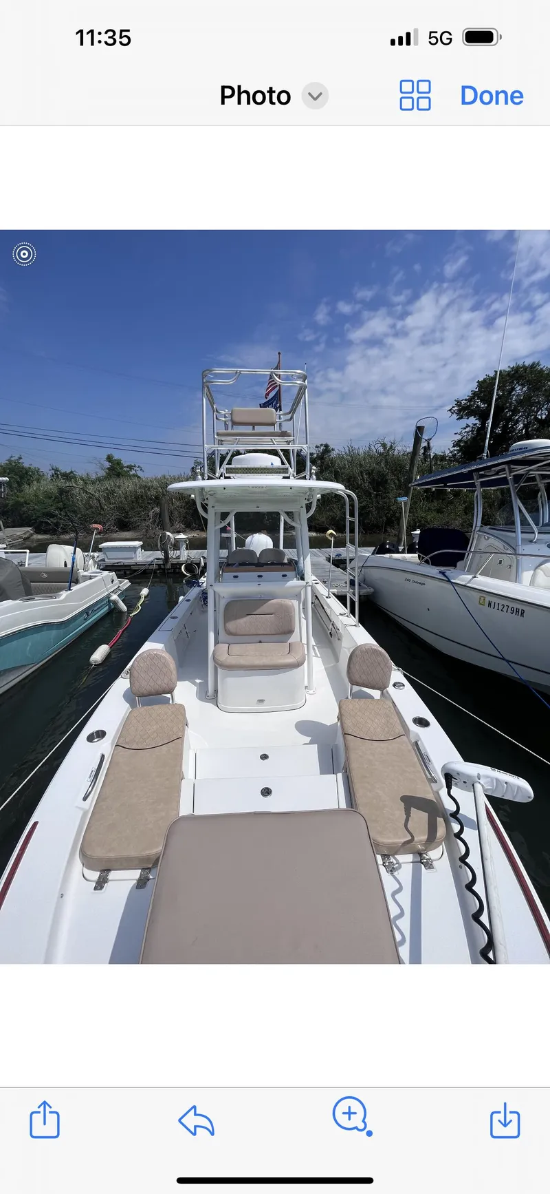 Slide: The Image of 2019 Sportsman Masters 247 Bay Boat docked, featuring spacious deck and seating. - 17