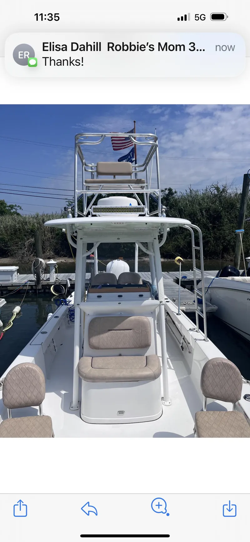 Slide: The Image of 2019 Sportsman Masters 247 Bay Boat docked, featuring seating and a tower with an American flag. - 18