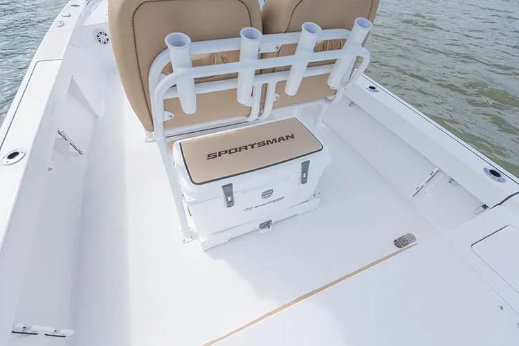 Slide: The Image of 2019 Sportsman Masters 247 Bay Boat interior with seating and cooler on deck. - 21