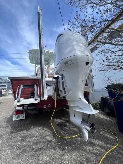 Slide: The Image of 2019 Sportsman Masters 247 Bay Boat with outboard motor, parked on a driveway. - 24