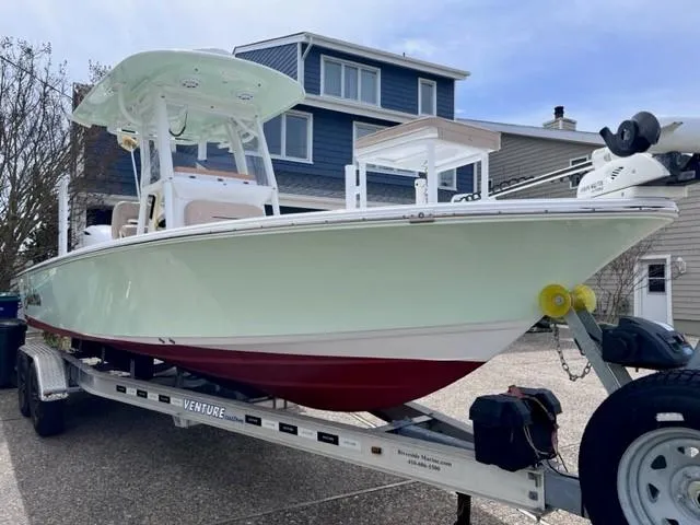 Slide: The Image of 2019 Sportsman Masters 247 Bay Boat on trailer, parked near residential houses. - 3