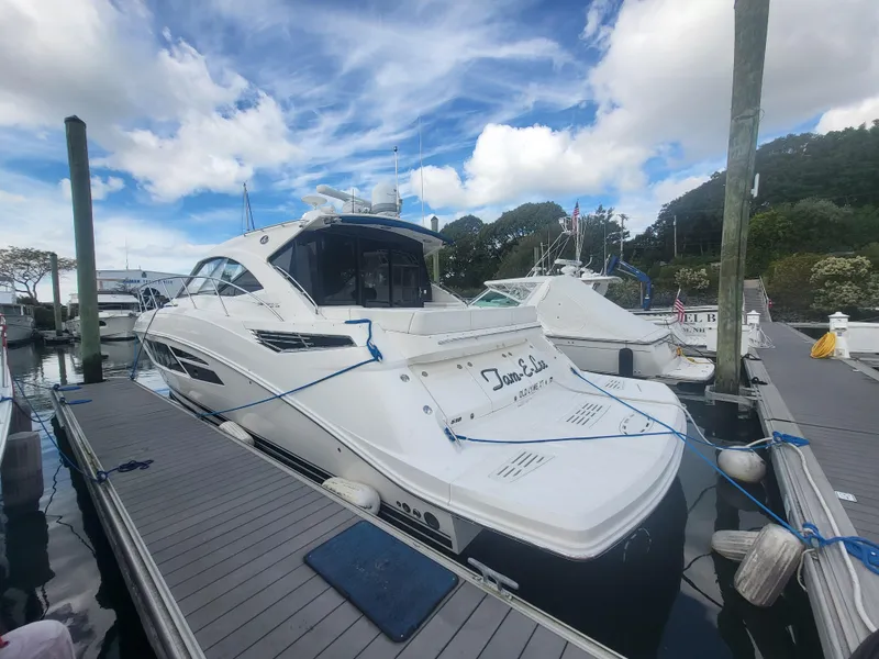 Slide: The Image of 2013 Sea Ray 510 Sundancer yacht docked at marina under blue sky. - 14