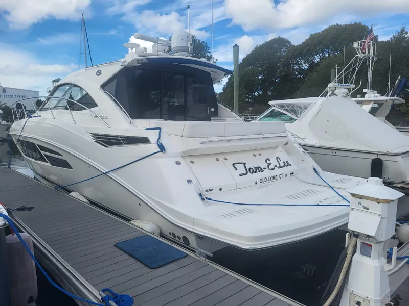 Slide: The Image of 2013 Sea Ray 510 Sundancer yacht docked at marina under blue sky. - 16