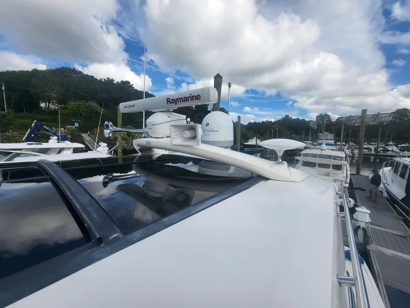 Slide: The Image of 2013 Sea Ray 510 Sundancer yacht with Raymarine radar, docked under cloudy sky. - 19