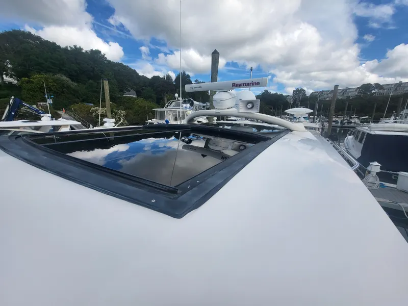 Slide: The Image of 2013 Sea Ray 510 Sundancer yacht with radar, docked under a partly cloudy sky. - 20