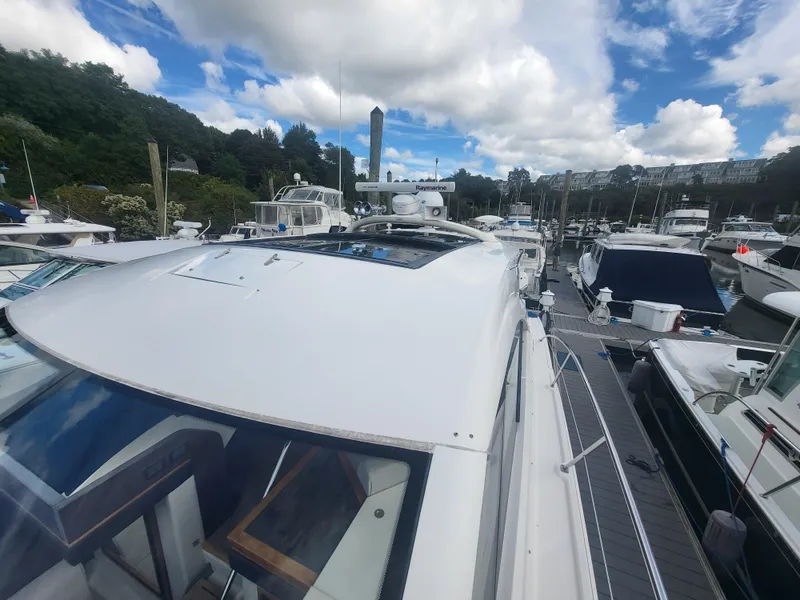 Slide: The Image of 2013 Sea Ray 510 Sundancer yacht docked at marina under cloudy sky. - 21