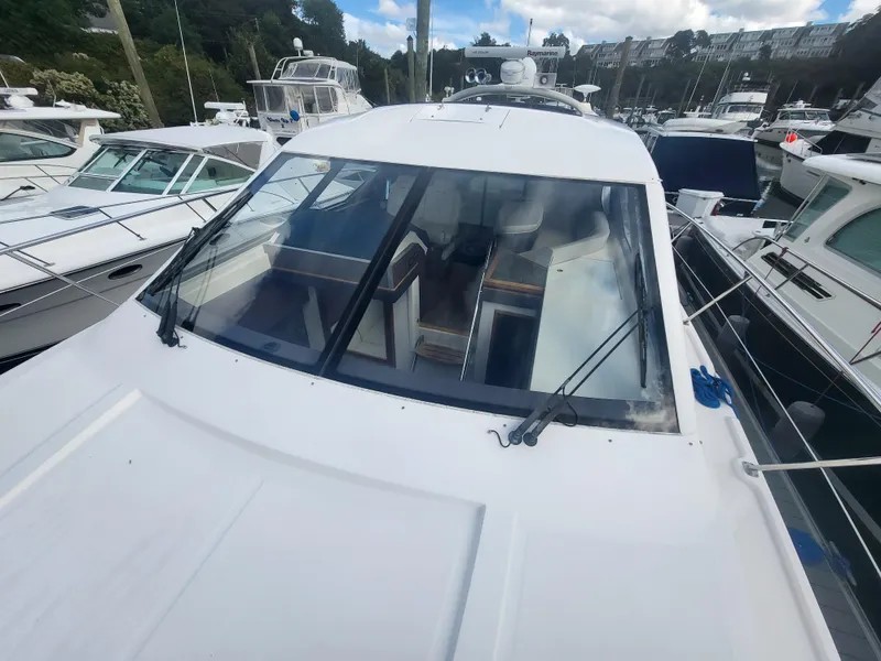 Slide: The Image of 2013 Sea Ray 510 Sundancer yacht docked at marina, front view. - 23