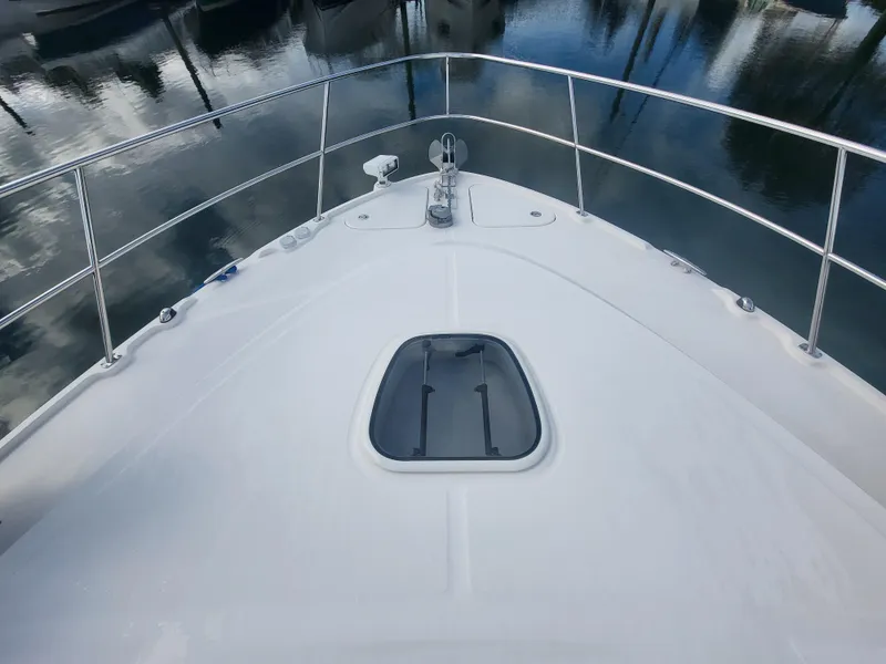 Slide: The Image of Bow view of 2013 Sea Ray 510 Sundancer yacht, featuring sleek design and railing. - 28