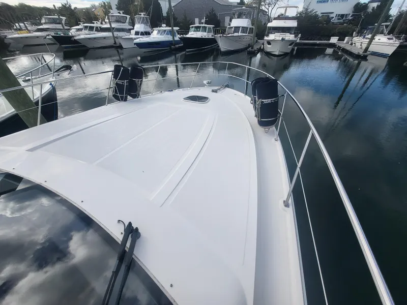 Slide: The Image of 2013 Sea Ray 510 Sundancer yacht docked in a marina, surrounded by other boats. - 29