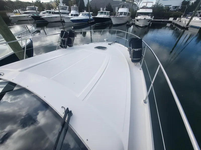 Slide: The Image of 2013 Sea Ray 510 Sundancer yacht docked in a marina, surrounded by other boats. - 30