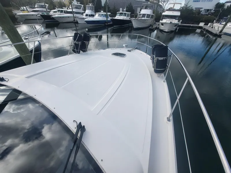 Slide: The Image of 2013 Sea Ray 510 Sundancer yacht docked in a marina, surrounded by other boats. - 31