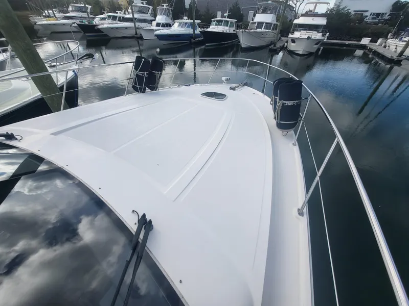 Slide: The Image of 2013 Sea Ray 510 Sundancer yacht docked in a marina, surrounded by other boats. - 32