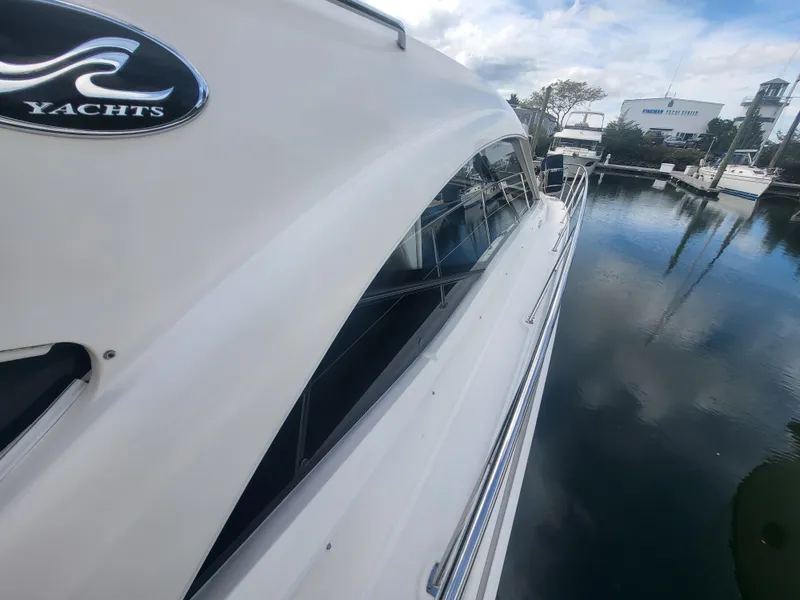Slide: The Image of 2013 Sea Ray 510 Sundancer yacht docked at marina, side view. - 35