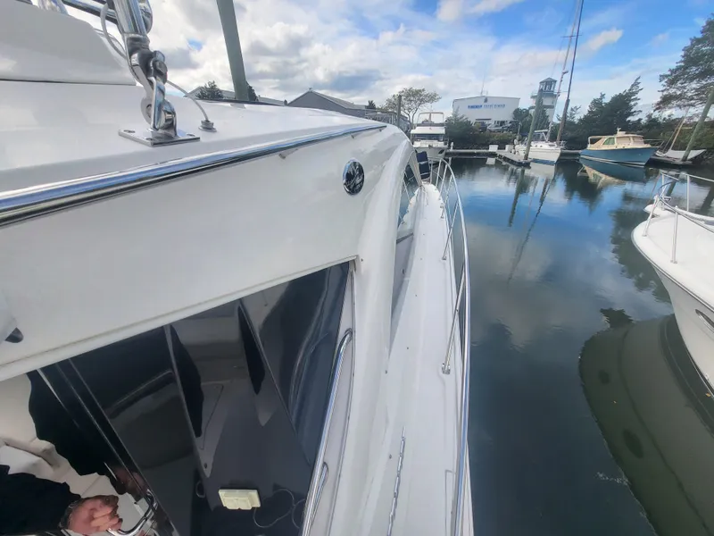 Slide: The Image of 2013 Sea Ray 510 Sundancer docked in a marina, reflecting on calm water. - 36