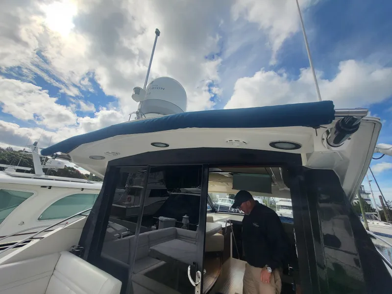 Slide: The Image of 2013 Sea Ray 510 Sundancer yacht with a person on deck under a cloudy sky. - 40