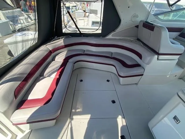 Slide: The Image of 1992 Regal 40 Commodore yacht interior with curved seating and maroon accents. - 10