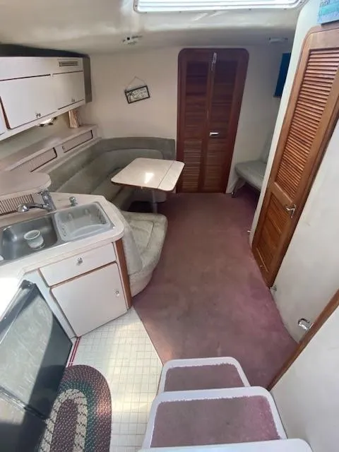 Slide: The Image of Interior of 1992 Regal 40 Commodore yacht with kitchen and seating area. - 11