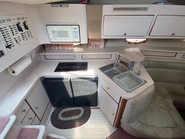 Slide: The Image of Interior of 1992 Regal 40 Commodore yacht kitchen with appliances and seating area. - 12