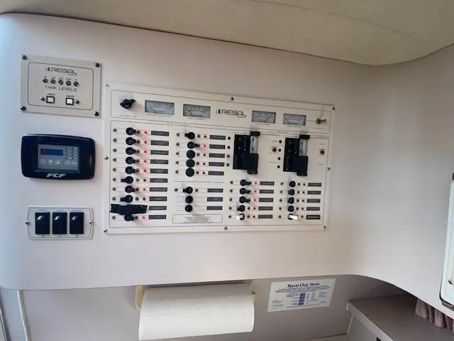 Slide: The Image of Control panel of a 1992 Regal 40 Commodore boat, featuring switches and gauges. - 15