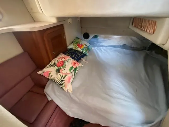 Slide: The Image of Cozy cabin interior of 1992 Regal 40 Commodore with floral pillows and seating. - 19