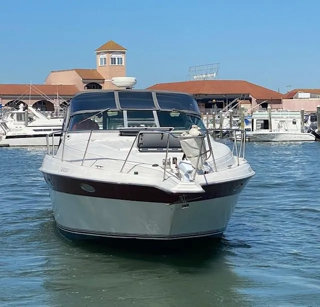 Slide: The Image of 1992 Regal 40 Commodore yacht docked at marina, clear blue sky background. - 2