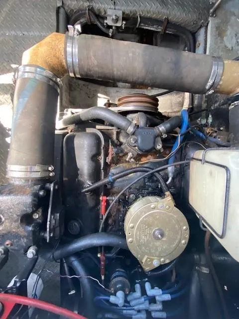 Slide: The Image of Engine of a 1992 Regal 40 Commodore boat, showing hoses and components. - 22